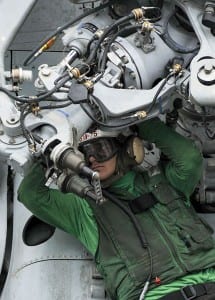 Mechanic fixing a problem on a chopper aboard the USS Nimitz.  America's weapons are extremely complex, a weakness in tactical terms. 