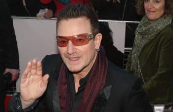 Bono, one of the international bourgeoisie's most laughable pets and clowns, is naturally rubbing elbows with the real powerful at Davos. 