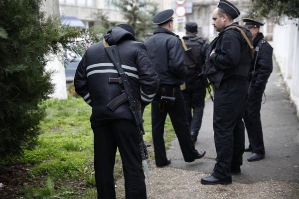 Russian navy personnel milling around a Ukrainian military installation. They have not been ordered to attack but to maintain a non hostile standoff.