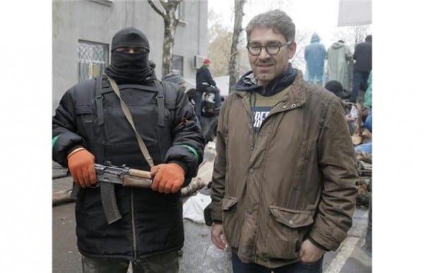 Western journalist standing by pro-Russia activist in Slavyansk, Eastern Ukraine.