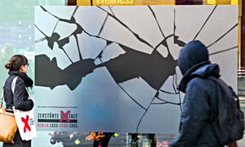 An enormous sticker simulating broken glass in a shop window in Berlin, Nov. 8, 2013. The stickers were part of a campaign mounted by the German History Museum in Berlin to commemorate "Kristallnacht." Photo/Reuters.