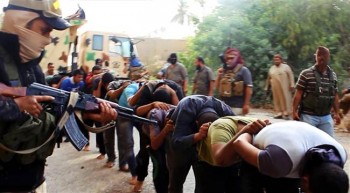 This image posted on a militant website on Saturday, June 14, 2014, which was provided by AP and has not been verified by NBC News, appears to show militants from the al-Qaeda-inspired Islamic State of Iraq and the Levant (ISIS) leading away captured Iraqi soldiers dressed in plain clothes after taking over a base in Tikrit, Iraq.