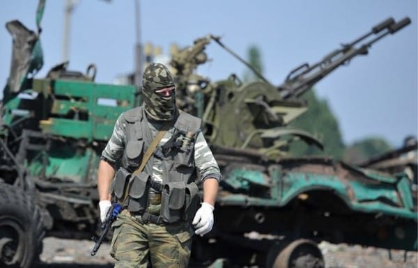 Novorussian soldier near captured equipment.