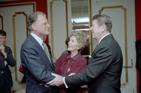 Few charlatans have occupied as spectacular a place as Billy Graham—"the spiritual advisor to presidents—a man who always blessed the imperial crusades as the duty of a pious nation. Here shaking hands with a secular charlatan, Ronald Reagan.