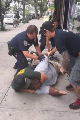 Cops ganging up on Garner, and clearly using too much force, despite his cries of difficulty breathing.  