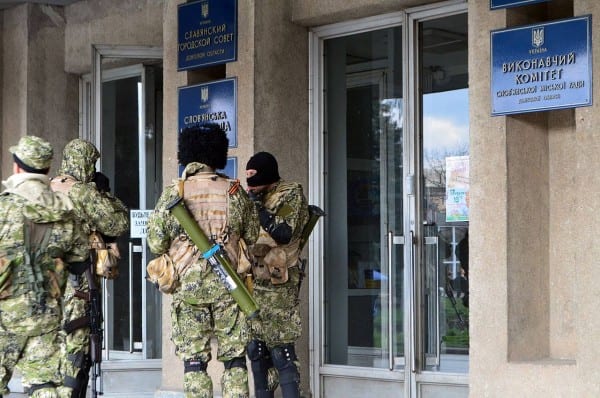 Sloviansk city council under control of Don Cossacks on April 14, 2014. Sloviansk city council under control of armed forces. The masked men are holding Kalashnikov assault rifles and having rocket launchers on their backs (very similar to Soviet/Russian RPG-26).  (Yevgen Nasadyuk (Євген Насадюк)