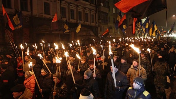 Activists of the Svoboda (Freedom) and Right Sector Ukrainian nationalist parties hold torches as they take part in a rally to mark the 106th birth anniversary of Stepan Bandera, one of the founders of the Organization of Ukrainian Nationalists (OUN), in Kiev January 1, 2015. (Reuters/Valentyn Ogirenko)