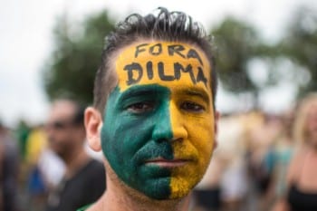 Under a constant regime of vicious propaganda issuing from the country's media, chiefly TV, many people demanded Rousseff's resignation. "Out with Dilma!" reads the demand on this guy's face. 