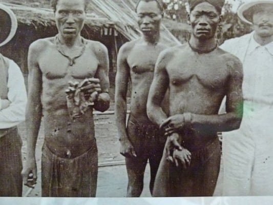 Leopold and his ruffian representatives set up a regime of terror to dominate the natives. Mutilation and brutal executions were widely practiced, both on the "trangressors" and their innocent families. The men are holding severed hands of recent victims of punishment. 