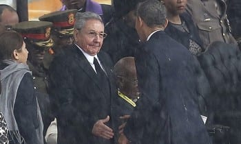 Barack Obama shakes hands with Cuba's President Raúl Castro at a memorial service for Nelson Mandela