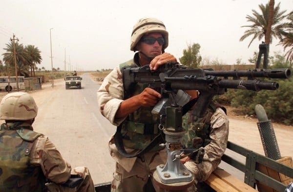 030527-N-5362A-001 Al Hillah, Iraq (May, 27th 2003) Ð Engineering Aide 1st Class Scott Lyerla, assigned to Naval Mobile Construction Battalion One Five (NMCB-15) maintains security for his convoy with an M-60 machine gun while driving through Al Hillah, Iraq. Operation Iraqi Freedom is the multi-national coalition effort to liberate the Iraqi people, eliminate Iraq's weapons of mass destruction, and end the regime of Saddam Hussein. U.S. Navy photo by Photographer's Mate 1st Class Arlo K. Abrahamson. (RELEASED)