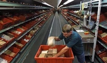 Worker David Lloyd handles an order in the active items area of the Defense Logistics Agency's giant storage facility outside Harrisburg, Pennsylvania June 13, 2012. Picture taken June 13, 2012. REUTERS/Tim Shaffer