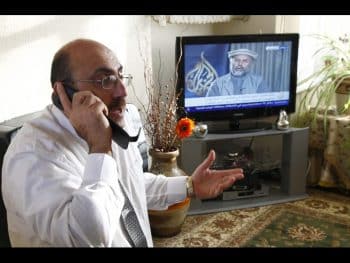 The director of the Syrian Observatory for Human Rights, Rami Abdulrahman, speaks on the phone in his home in Coventry, central England December 6, 2011. With only a few hours sleep, a phone glued to his ear and another two ringing, the fast-talking director of arguably Syria's most high-profile human rights group is a very busy man. "Are there clashes? How did he die? Ah, he was shot," said Rami Abdulrahman into a phone, the talk of gunfire and death incongruous with his two bedroom terraced home in the unassuming city of Coventry in central England, from where he runs the Syrian Observatory for Human Rights. Photograph taken on December 6, 2011. REUTERS/Mohammed Abbas (BRITAIN - Tags: POLITICS SOCIETY)